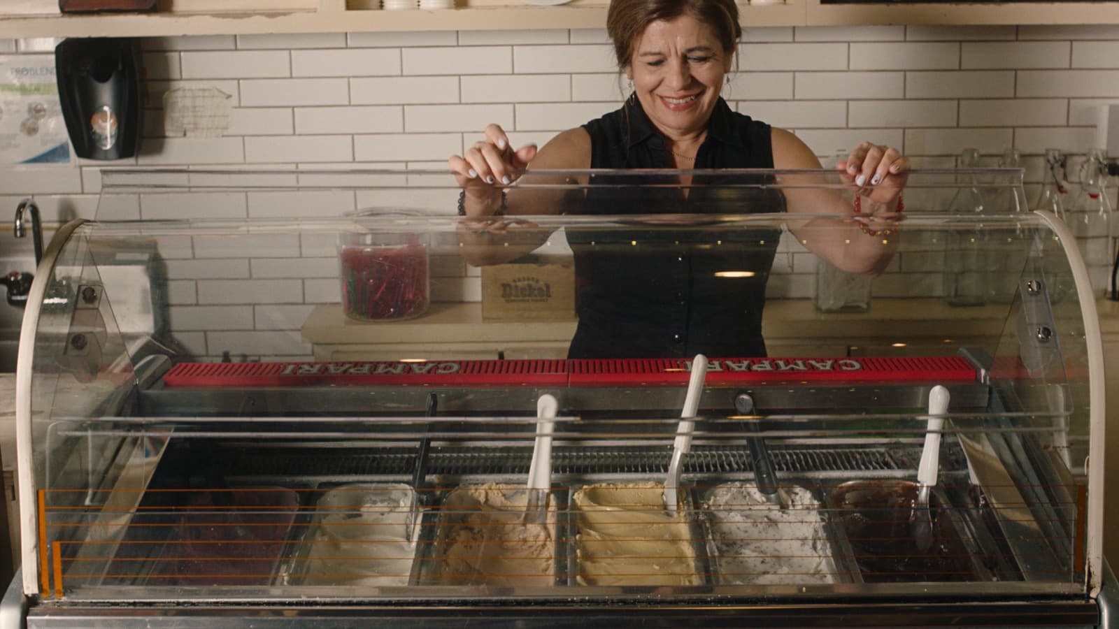 Small business owner serving gelato behind the counter