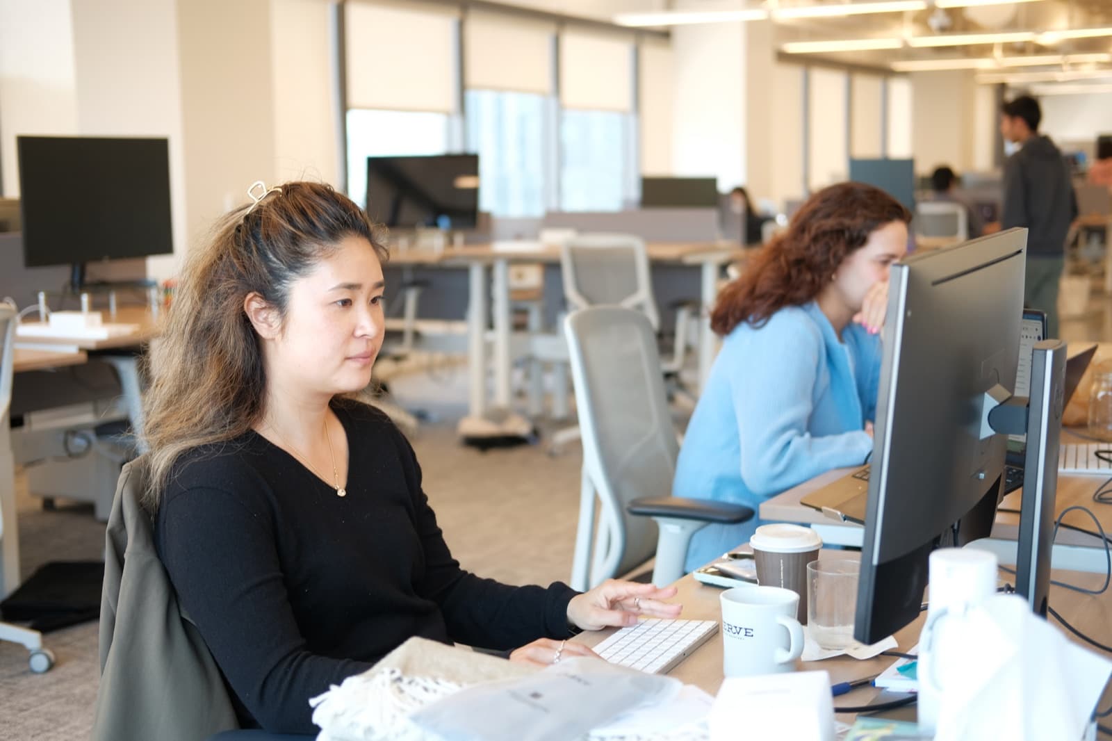 Teammate focused at her desk