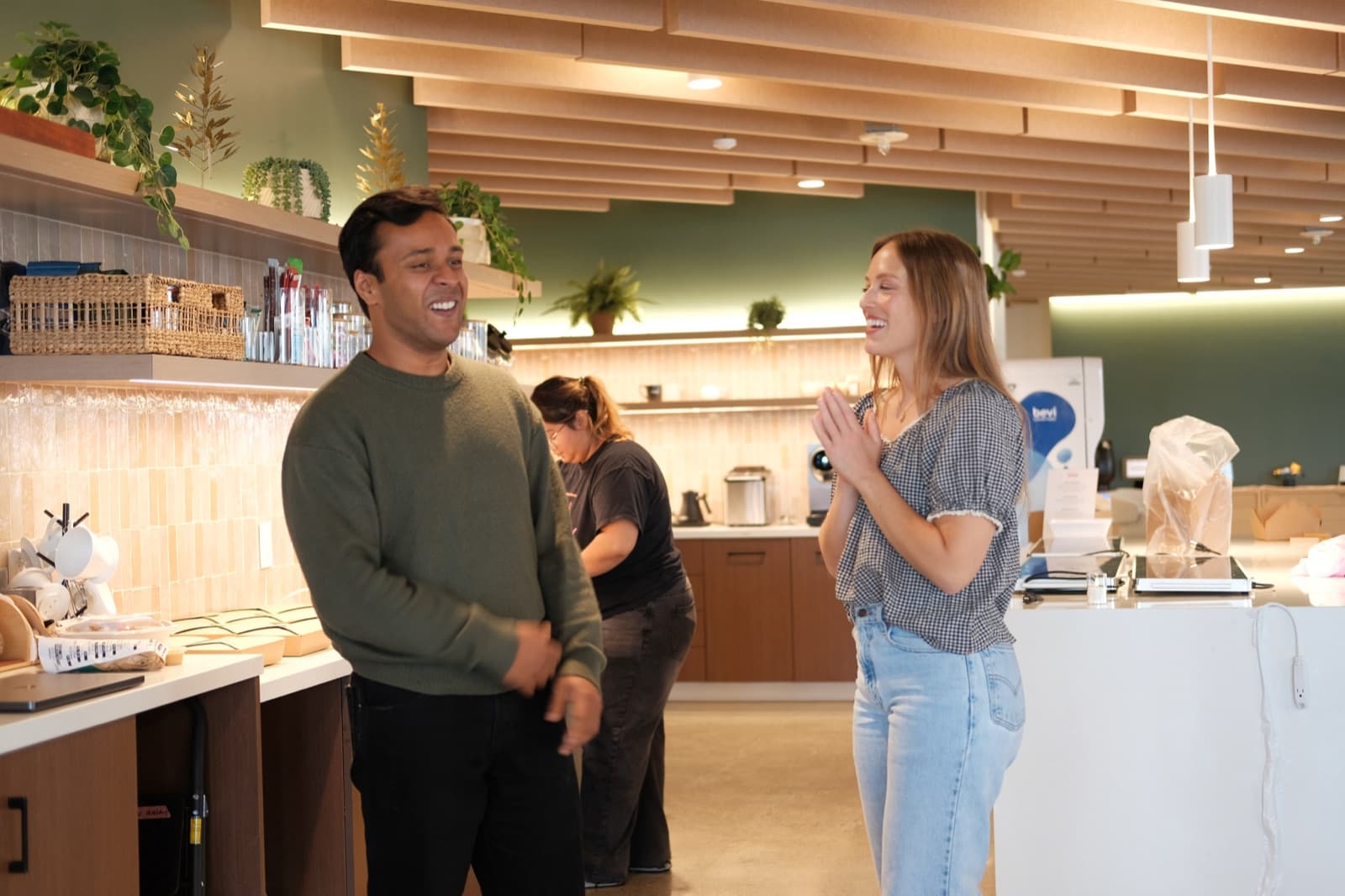 Teammates chatting in the office kitchen