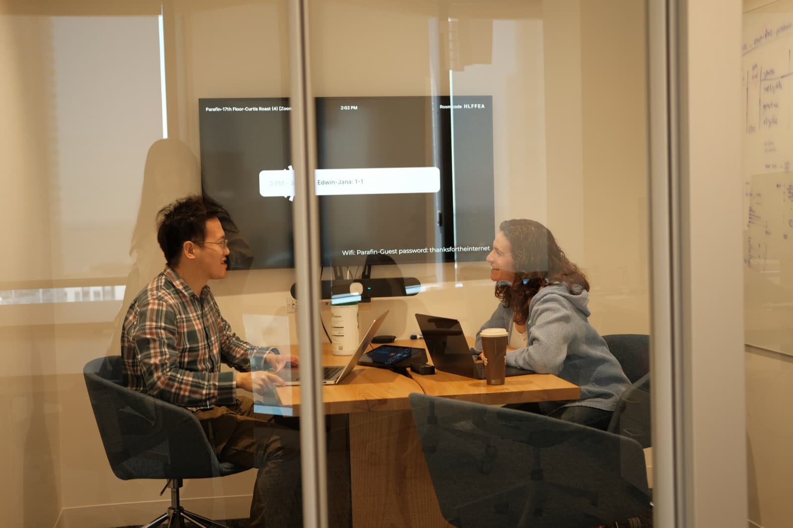 Two teammates working in a meeting room