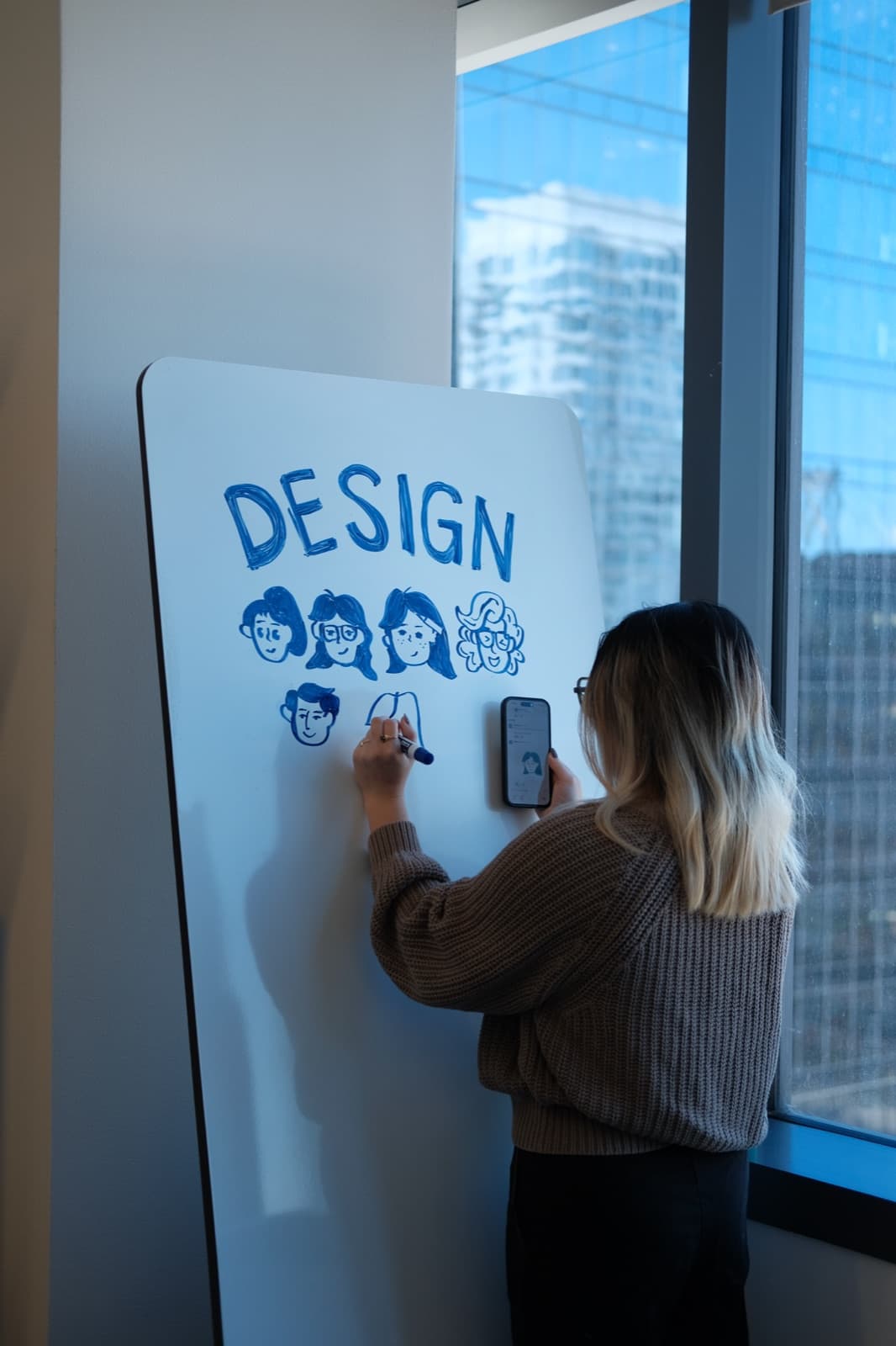 Designer sketching on a whiteboard
